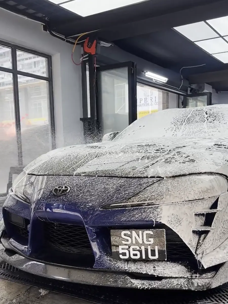 Blue Toyota Supra covered in snow foam