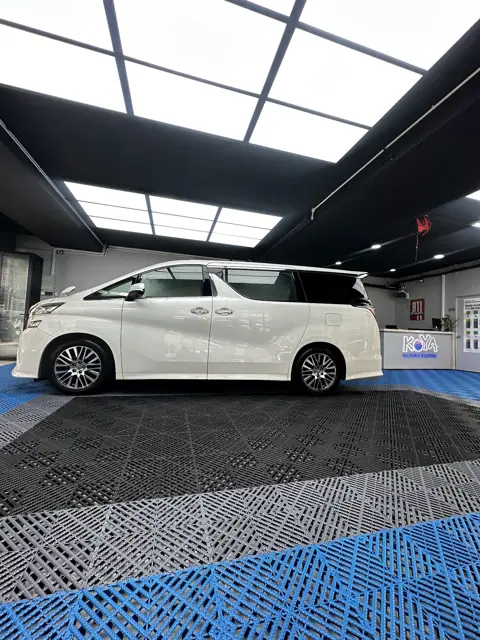 White Toyota Alphard side view in the KOYA bay