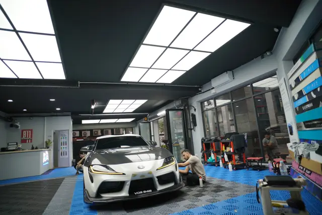 White Toyota Supra under the KOYA bay lights