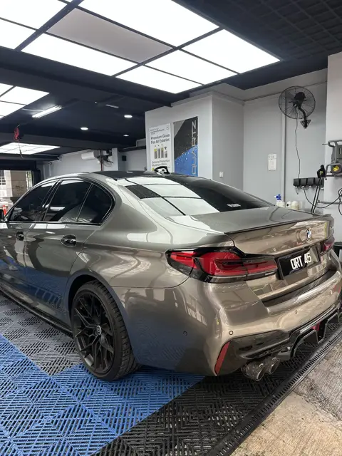 Grey BMW M5 rear three-quarter after detailing