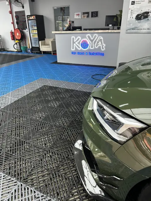 Audi RS5 headlamp detail beside the KOYA counter