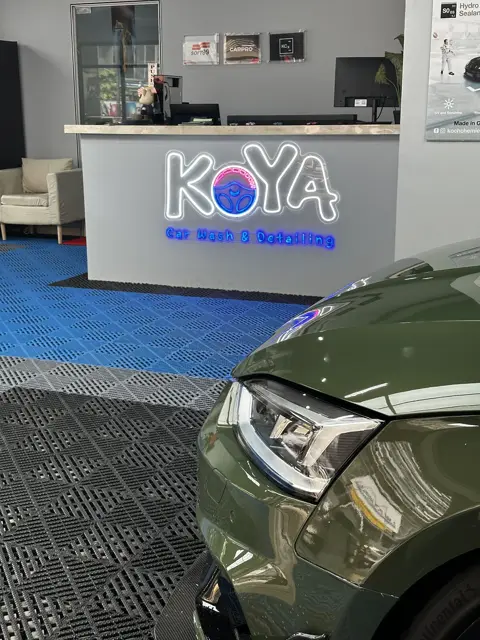 Audi RS5 headlamp detail beside the KOYA counter