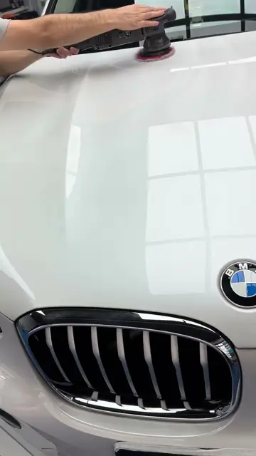 Polishing a white BMW X4 bonnet