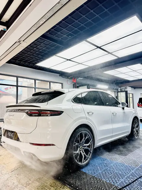 White Porsche Cayenne pressure rinse