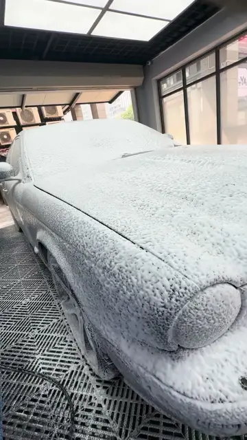 Jaguar fully covered in snow foam