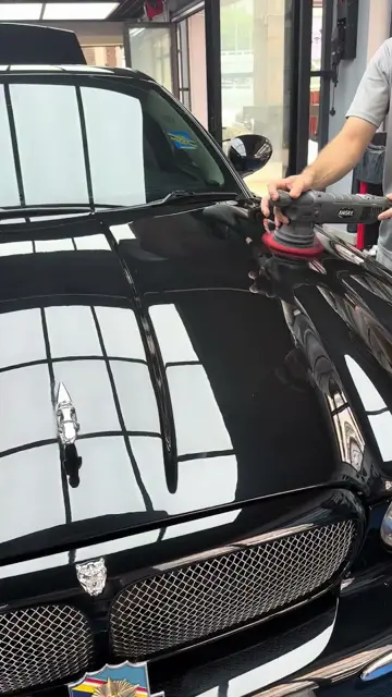 Machine polishing a black Jaguar