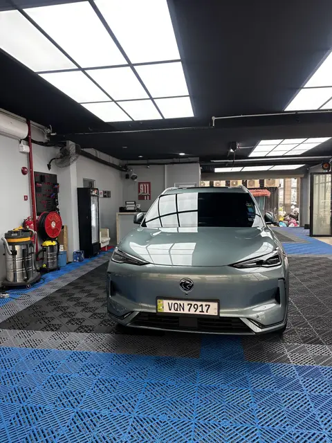 Green electric car front after a wash at KOYA