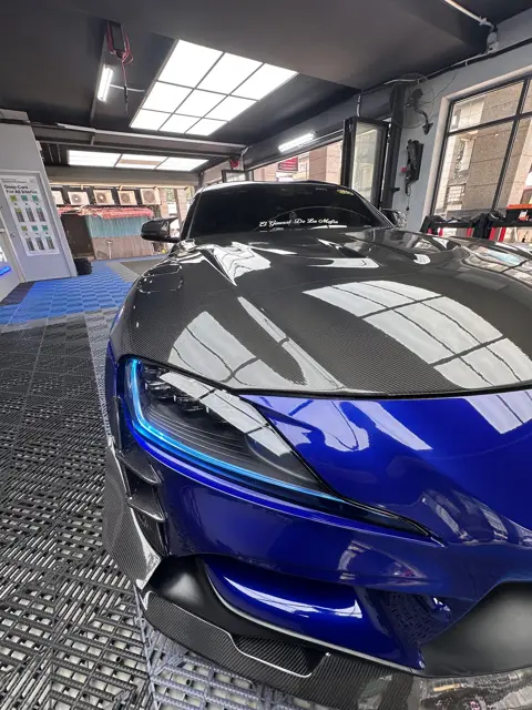 Close front view of a blue Toyota Supra after detailing