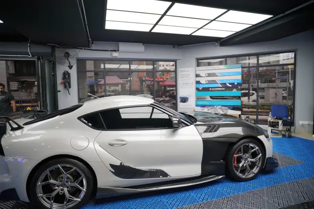 White Toyota Supra side profile inside KOYA