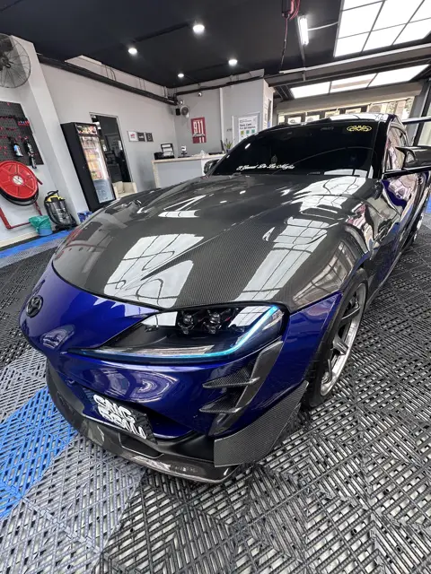 Blue Toyota Supra with carbon bonnet in the KOYA bay